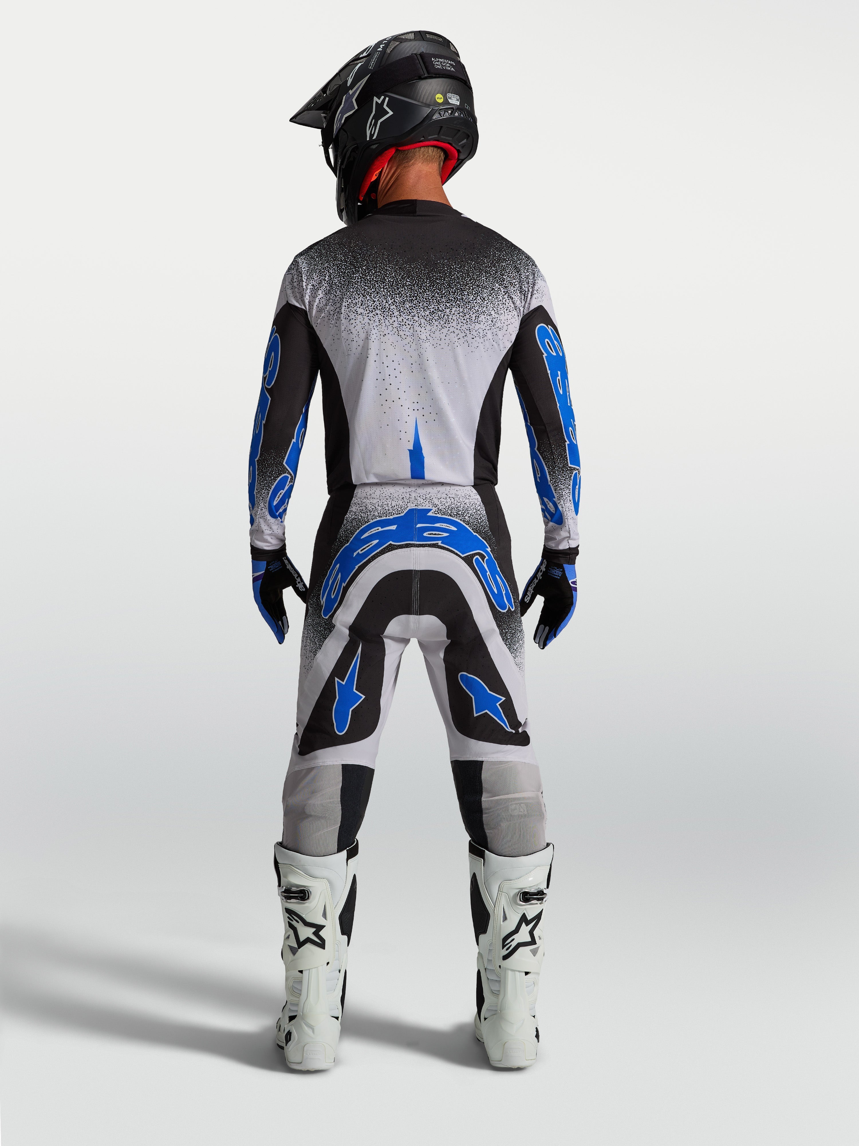 Alpinestars Supertech Hiten AFD Hose, Herren-Motocross-Rennbekleidung in Blau und Weiß, athletische Rückansicht.