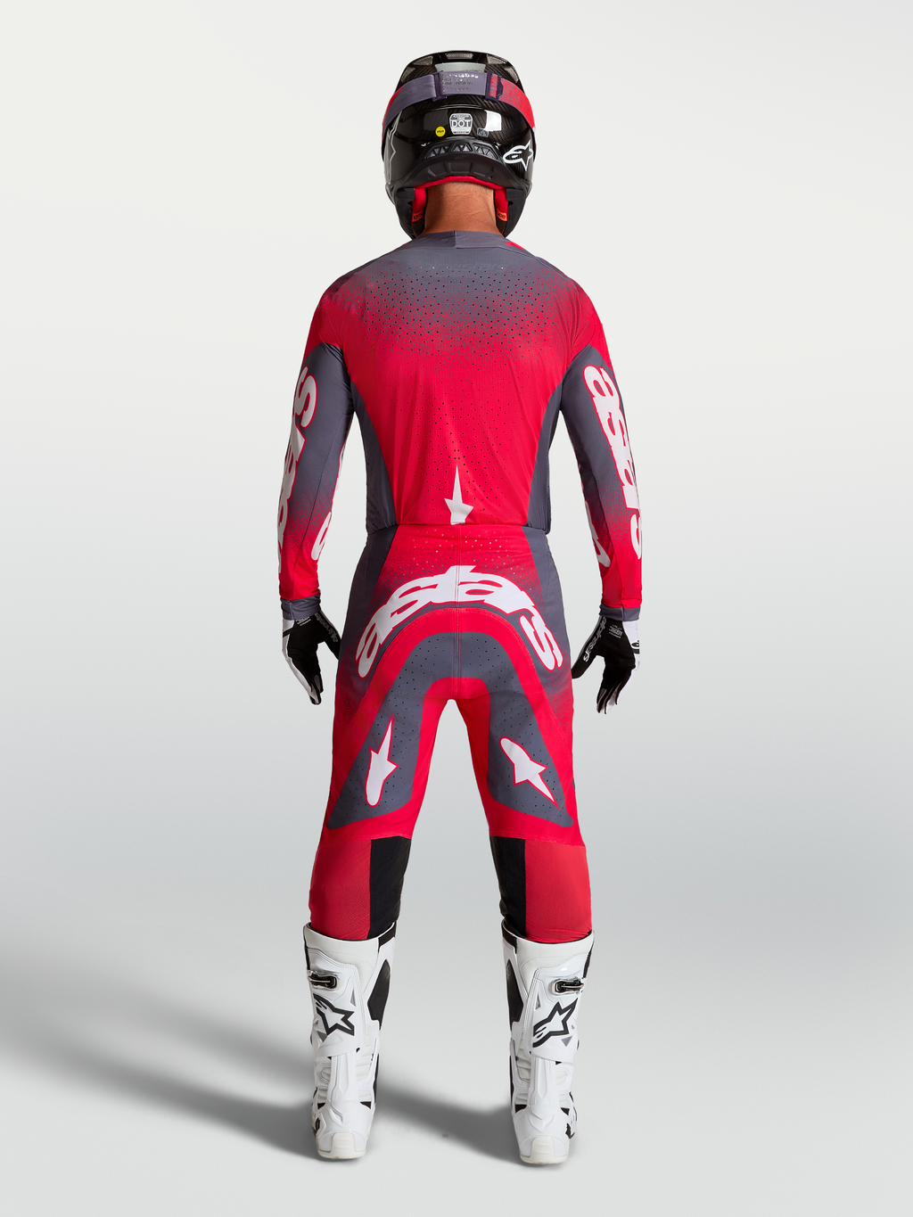 Alpinestars Supertech Hiten AFD Gear Set und Hose, Motocross-Rennbekleidung in Rot Fluo und Grau, Rückansicht am Model.