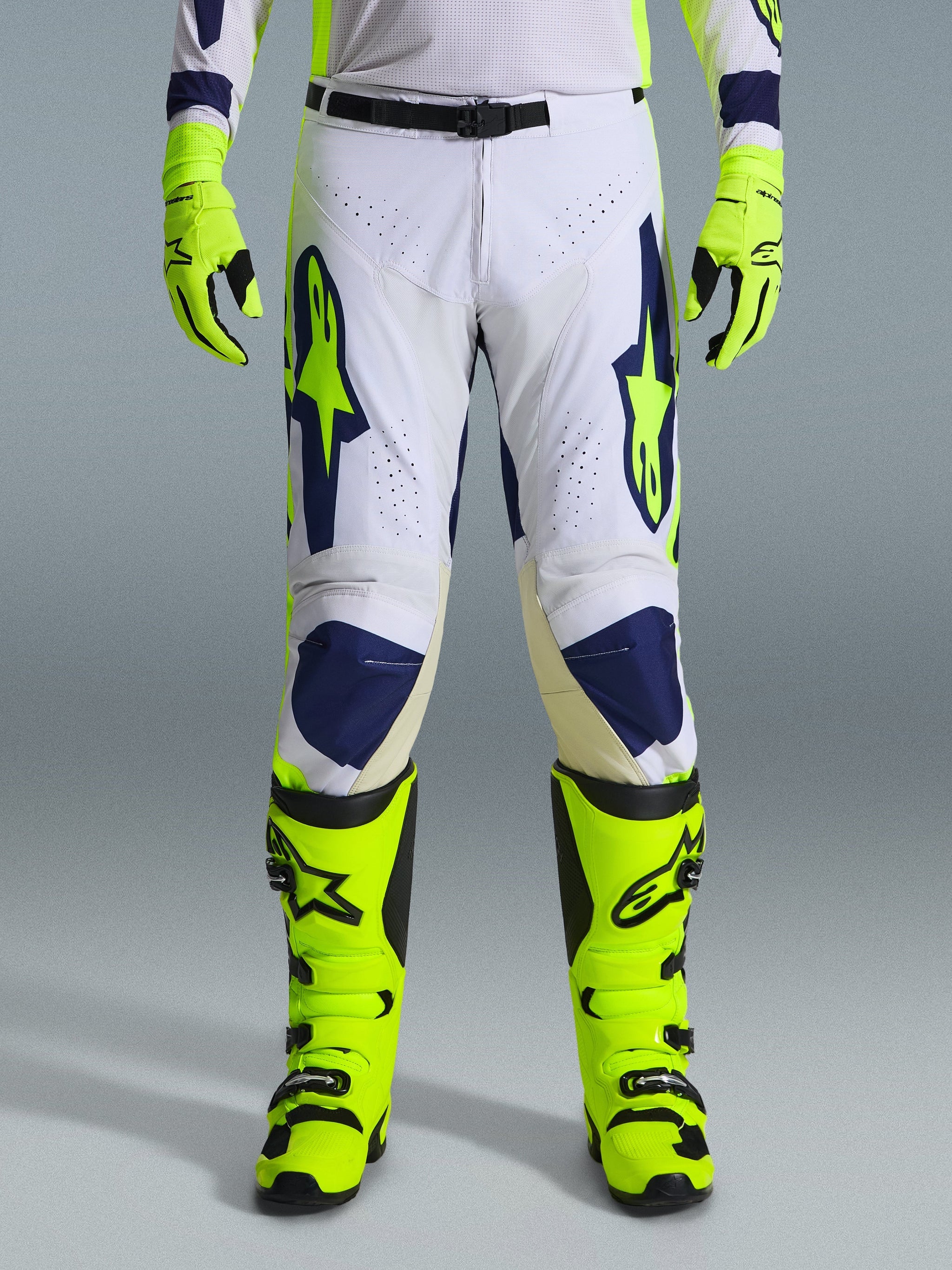 Alpinestars 2026 Racer Air Riway Pants, Motocross Pants, Light Gray Yellow Fluo and Blue, worn with matching neon yellow gloves and boots, featuring perforated front panels for airflow and bold blue and yellow branding, athletic design for off-road performance