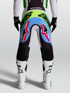 Alpinestars Supertech Dyna Herren-Motocross-Hose, Rückansicht in Helllila und Neongrün mit perforierten Stretcheinsätzen.