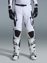 Alpinestars 2026 Racer Riway Pants, Motocross Pants, White and Black, worn with matching white and black motocross boots and black gloves, featuring bold black Alpinestars branding on the thighs, technical design for off-road performance.