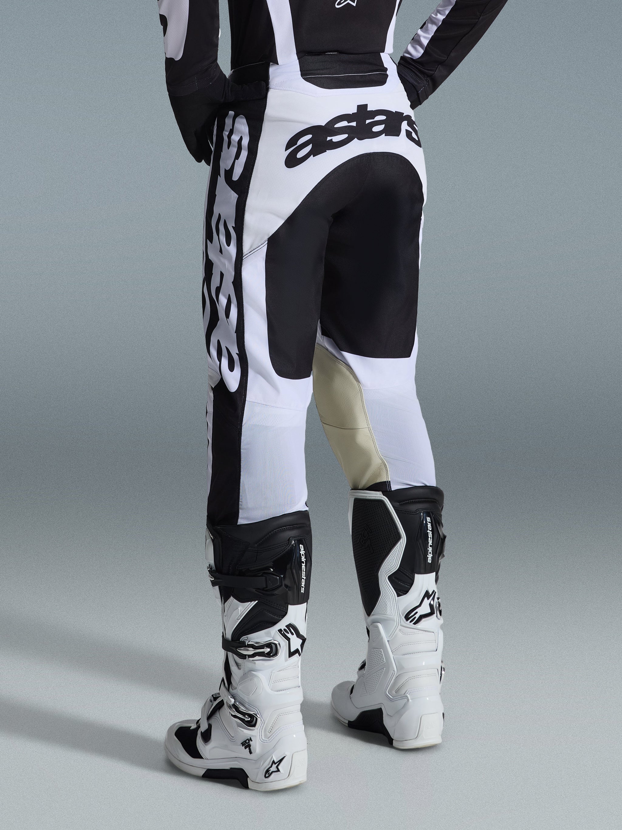 Alpinestars 2026 Racer Riway Pants, Motocross Pants, White and Black, back view showing bold black branding on the seat and sides, tan goat leather inner knee panels, worn with matching white and black motocross boots
