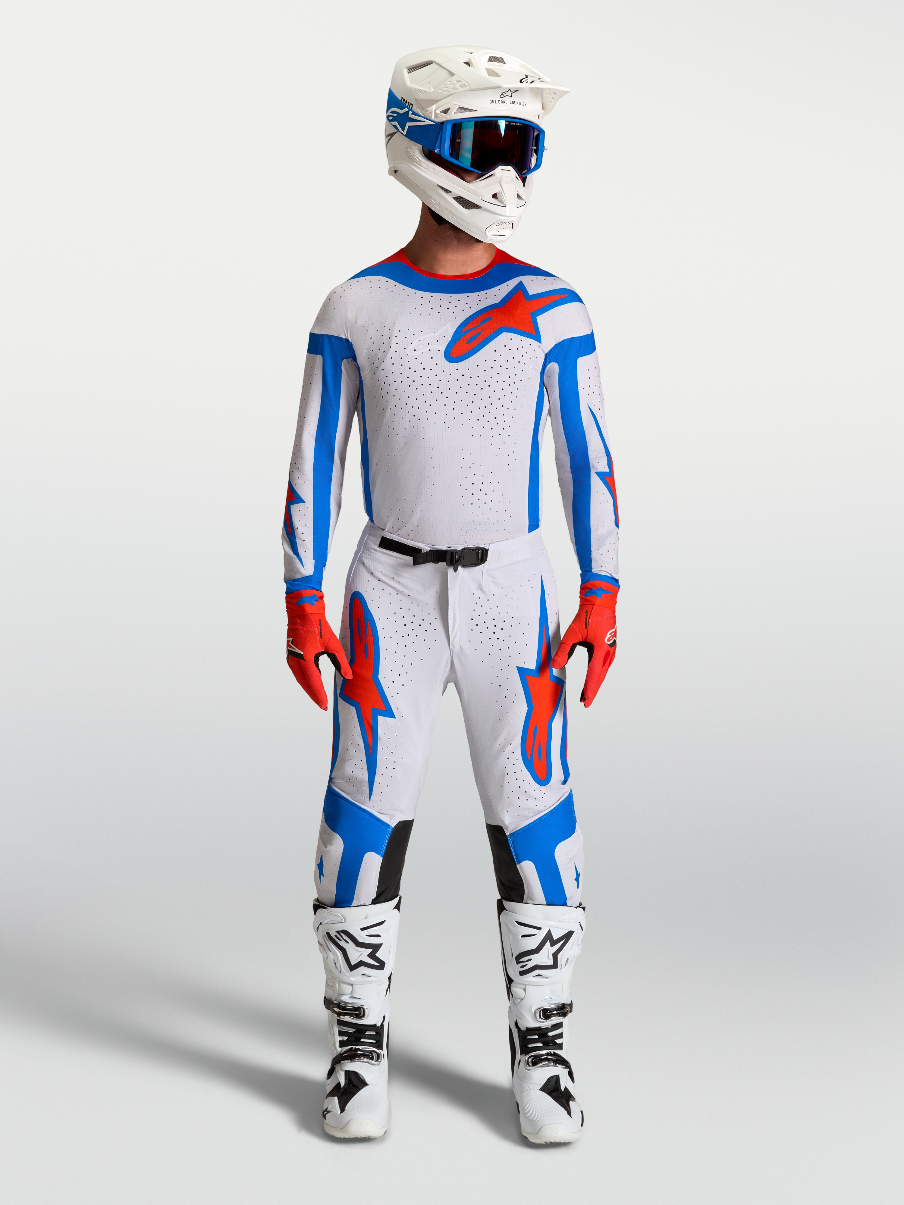 Alpinestars Supertech Vesta Motocross-Set in Helllila und Kardinalrot, bestehend aus Renntrikot, Hose und Stiefeln.