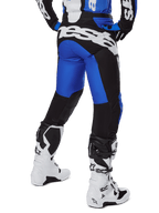 Alpinestars 2025 Racer Veil Pants, Motocross Pants, Blue and Black, rear view showing large white branding on the seat, worn with matching jersey and white boots, durable technical material for off-road riding