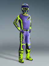 Motocross rider wearing Alpinestars 2026 Racer Portl racing gear, Purple and Yellow Fluo jersey and pants, neon yellow boots, purple gloves, and matching helmet, full-body coordinated outfit for off-road motocross performance.