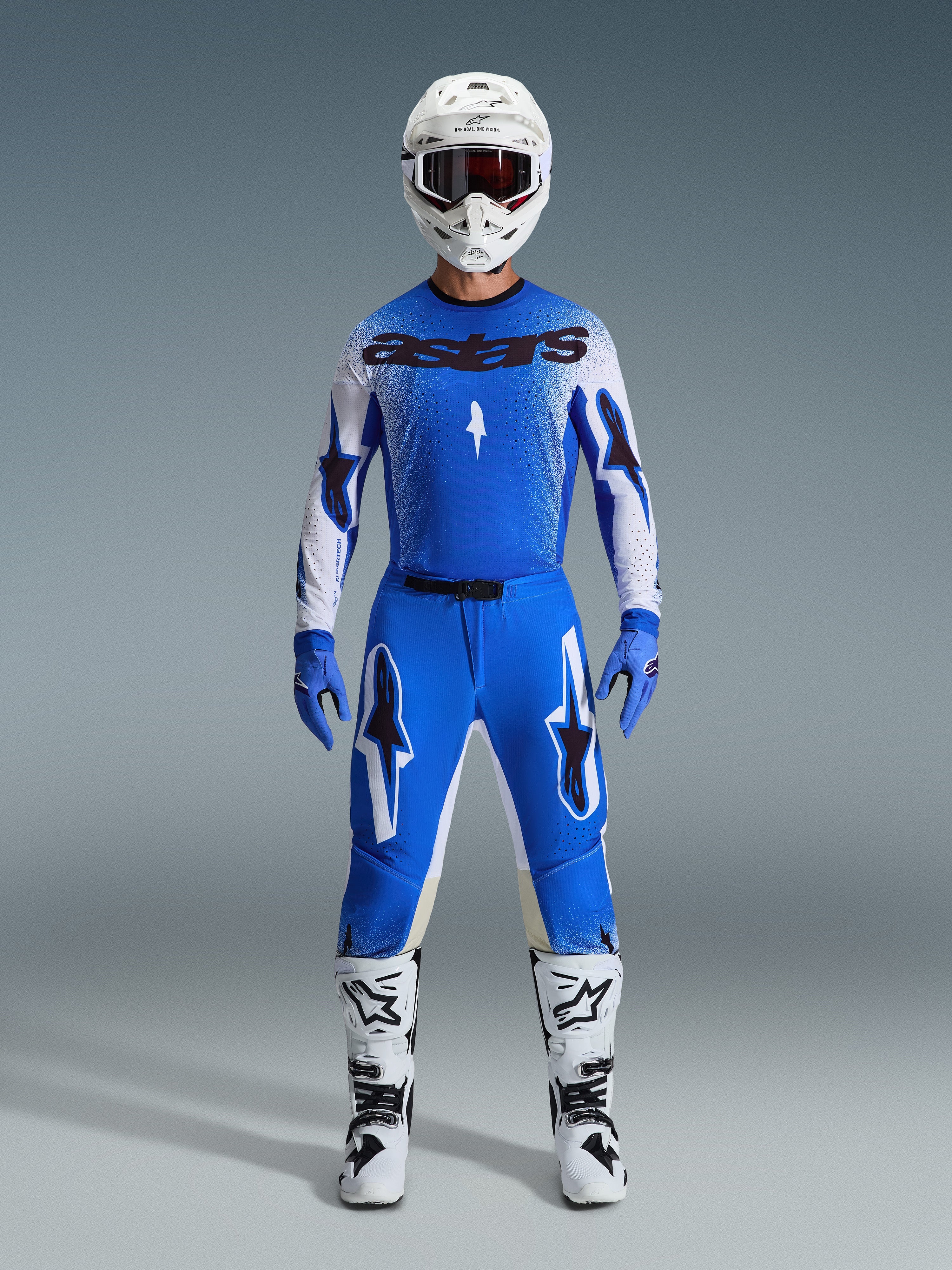 Alpinestars 2026 Supertech Scenz Gear Set, Motocross Racing Gear, Ucla Blue and White, complete racing outfit featuring a blue jersey with black 'astars' logo, matching pants with star graphics, white helmet with dark goggles, blue gloves, and white boots with black accents