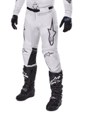 Alpinestars 2025 Racer Hollow Pants, Motocross Pants, White and Grey Camo, featuring large black outlined star logos and black leather inner knee panels, worn with black motocross boots and gloves, durable design for off-road racing.