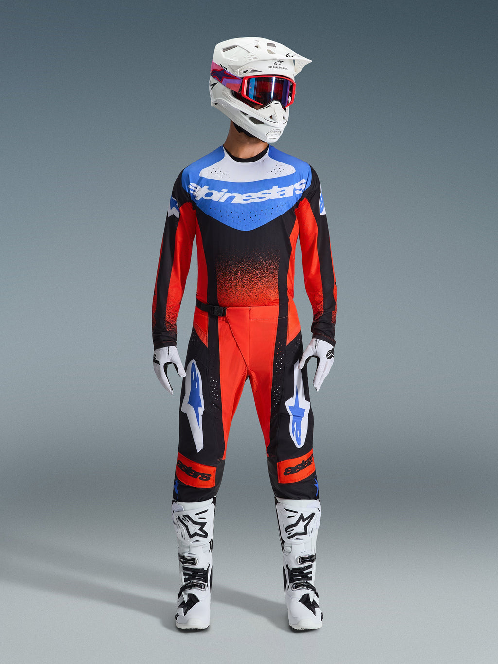 Alpinestars 2026 Techstar Knif Gear Set, Motocross Racing Gear, Red and Black with Blue Accents, complete MX outfit including jersey, pants, white helmet with pink and blue graphics, white gloves, and white boots, professional off-road racing equipment