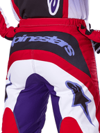 Alpinestars 2025 Fluid Wurx Hose, Motocross-Hose, Lila und Hellrot, Detailansicht der Rückseite mit markantem Alpinestars-Branding auf dem schwarzen Gesäßbereich, Farbblock-Design in Rot, Weiß und Lila, professionelle Offroad-Rennausrüstung