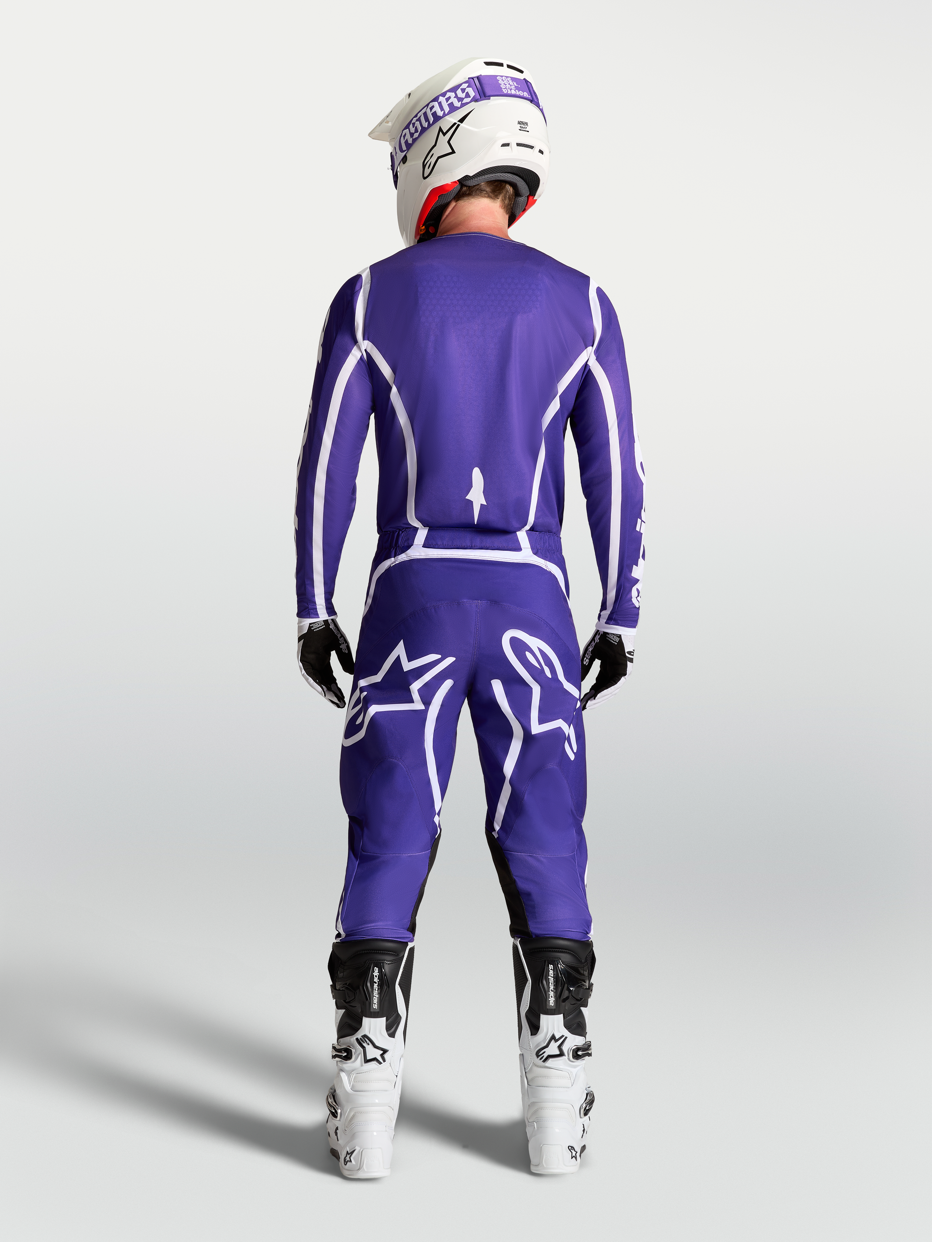 Alpinestars Fluid Apex V2 Pants, Men's Motocross Gear in Deep Blue and White, rear view on model with white racing boots.