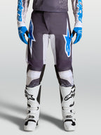 Alpinestars Fluid Drag Hosen für Motocross, Grau und Blau, vorgekrümmte Beine und ergonomischer Schutz aus Poly-Gewebe.