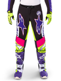 Alpinestars Limited Edition Supertech Dirt Studios Pants, Motocross Pants, White Purple and Yellow Fluo, featuring black panels with neon yellow and pink accents, large purple star logos, shown with matching neon yellow gloves and purple racing boots, durable off-road racing apparel