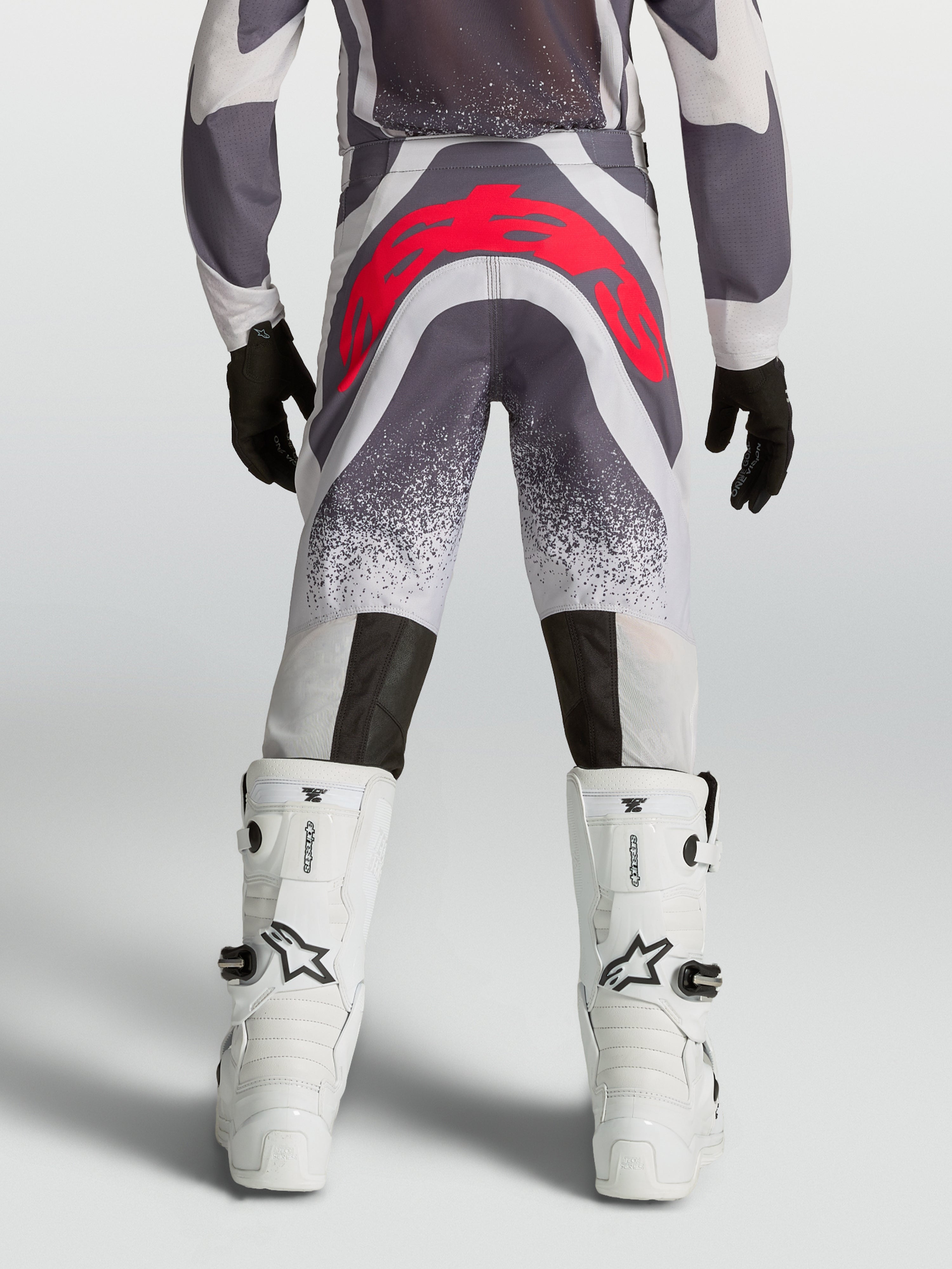 Alpinestars Youth Supertech Swan Motocross Pants in Gray and Red Fluo, rear view showing athletic fit and reinforced seat.