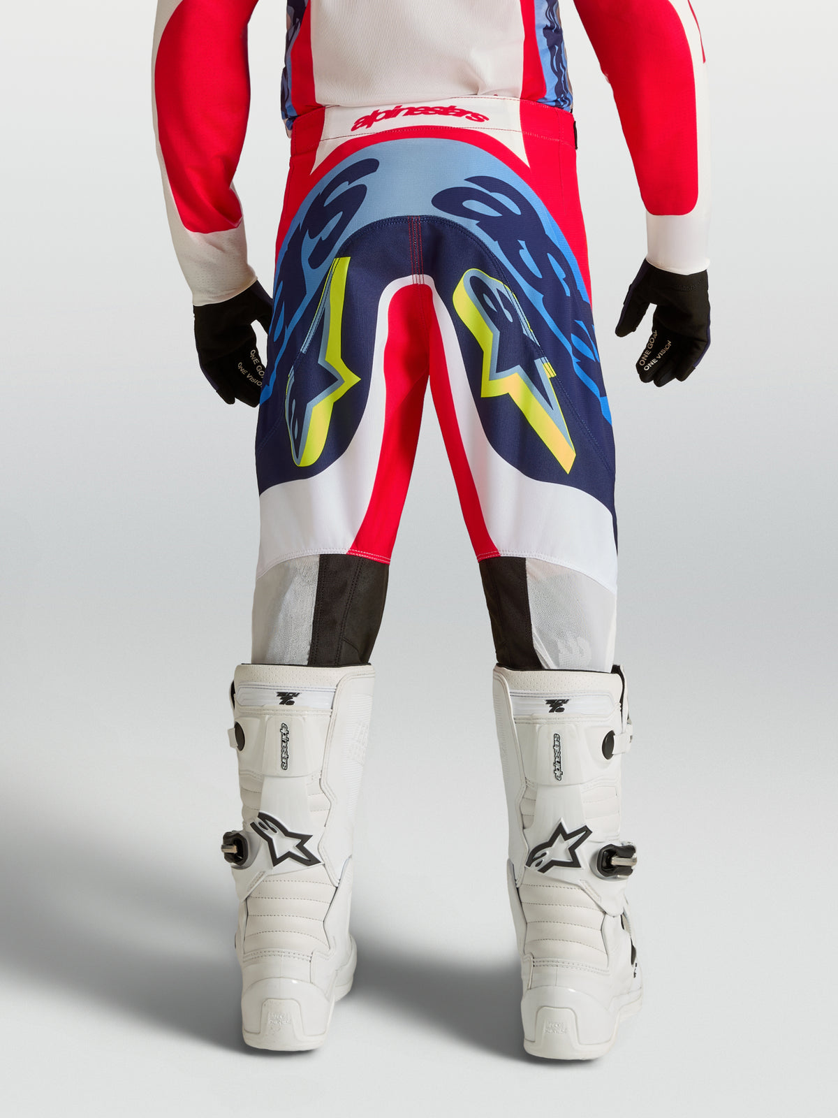 Alpinestars Youth Supertech Dyna Pants in red and navy blue, professional youth motocross gear with durable stretch construction.