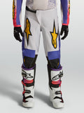 Alpinestars Youth Fluid Drag Pants, white and blue motocross pants with gold graphics and ergonomic fit for off-road racing.