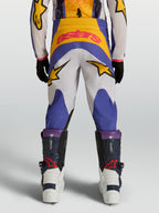 Alpinestars Youth Fluid Drag Pants, youth motocross gear in blue and gold, featuring a durable 600D construction and star graphics.