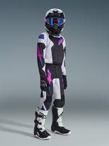 Alpinestars 2026 Youth Fluid Grid Pants, Motocross Pants, Black Light Gray and Purple, worn by a youth rider with matching jersey, helmet, goggles, and boots, featuring bold pinkish-purple logos and a durable athletic design for off-road racing.