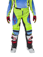 Alpinestars Youth 2024 Racer Hoen Pants, Motocross Pants, Yellow Fluo and Blue Night Navy, featuring red star logos on the thighs, worn with matching jersey, red and black gloves, and white, black, and red motocross boots, durable gear for off-road riding