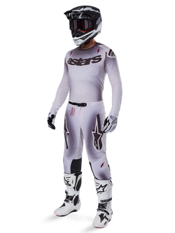 Alpinestars 2025 Supertech Maker Gear Set, complete motocross outfit, white and grey gradient with black branding and red accents, includes helmet with goggles, jersey, pants, white boots, and gloves, sleek performance-driven design for off-road racing