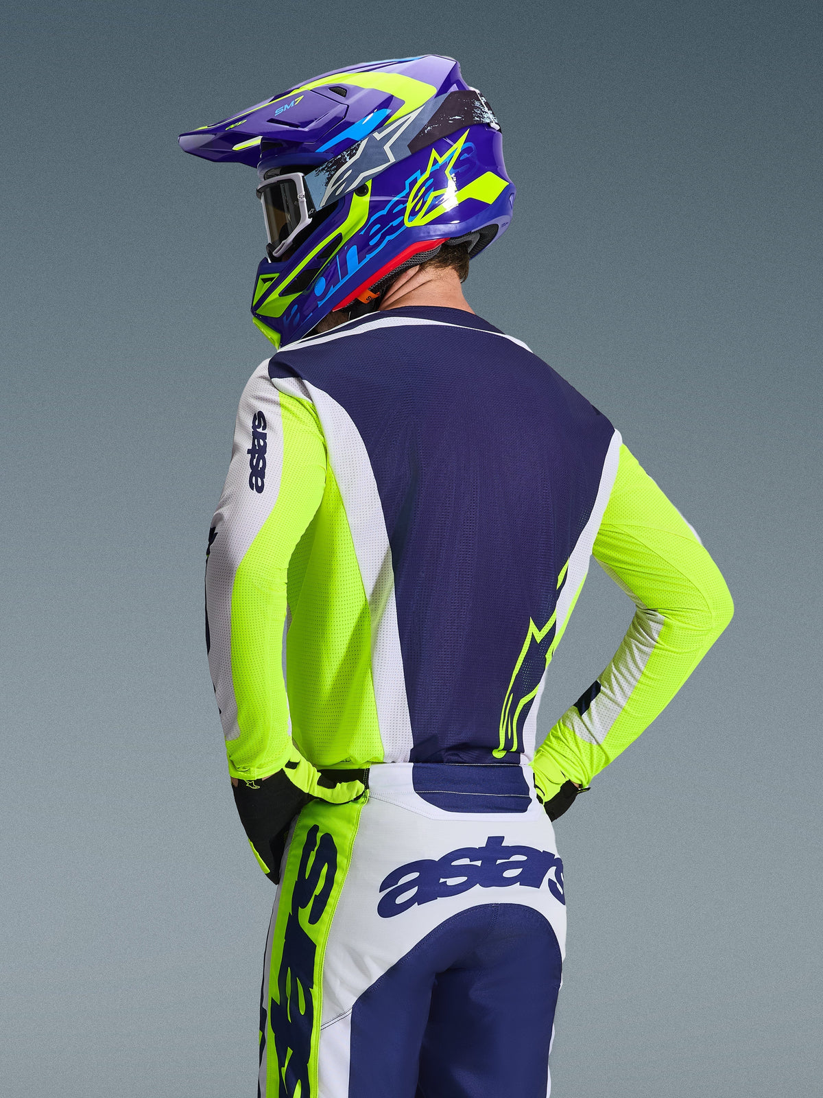 Alpinestars 2026 Racer Air Riway Jersey, Motocross Jersey, Light Gray Yellow Fluo Blue, back view of rider wearing matching pants and helmet, athletic race fit with breathable mesh panels for off-road racing