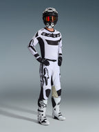 Alpinestars 2026 Racer Riway Gear Set, Motocross rider in a white and black racing kit, white jersey with black 'astars' chest logo, white pants with black accents, black helmet with orange goggles, white boots, coordinated gear for motocross and off-road riding