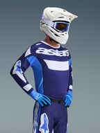 Alpinestars 2026 Racer Riway Gear Set, Motocross rider wearing navy blue and light blue jersey with white 'astars' branding, matching navy blue pants with white accents, white helmet with blue goggles, and blue gloves, complete professional outfit for off-road racing