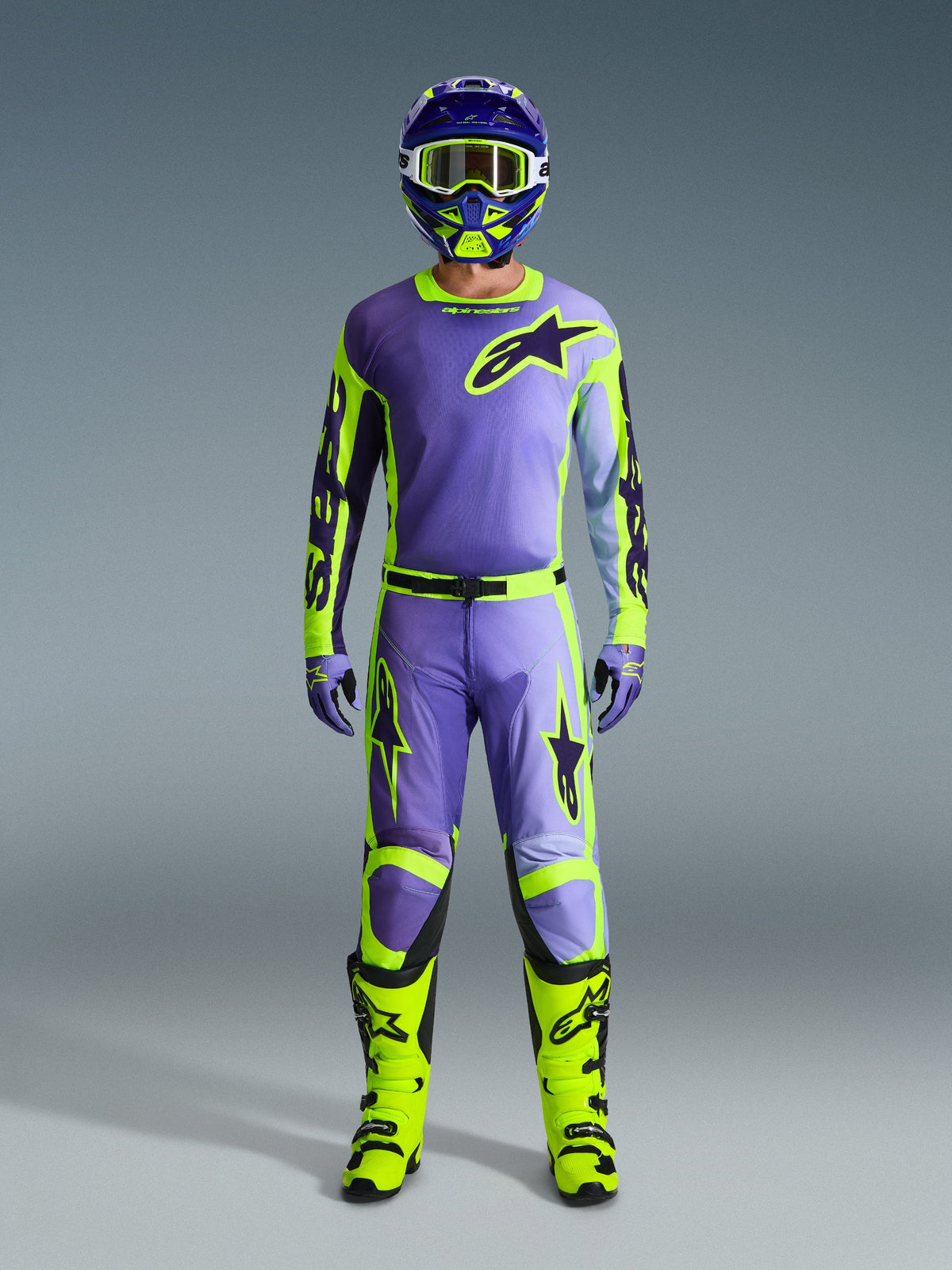 Alpinestars 2026 Racer Portl Jersey, Purple and Yellow Fluo, worn as part of a complete motocross gear set with matching pants, helmet, and bright neon yellow boots, professional off-road racing outfit.