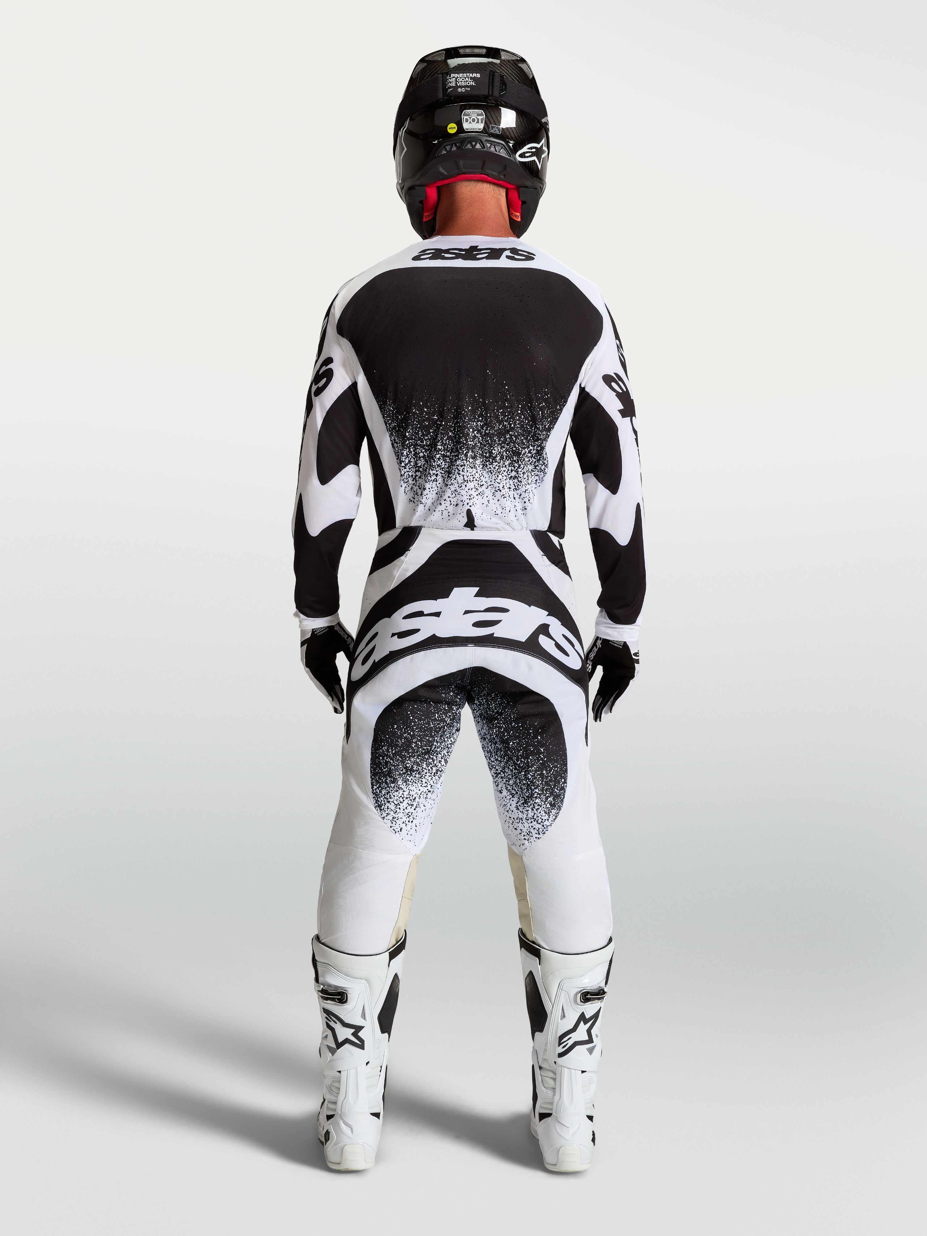 Alpinestars Techstar Swan Trikot und Gear Set, Herren-Motocross-Outfit, Schwarz und Weiß, Rückansicht mit Splatter-Grafiken.