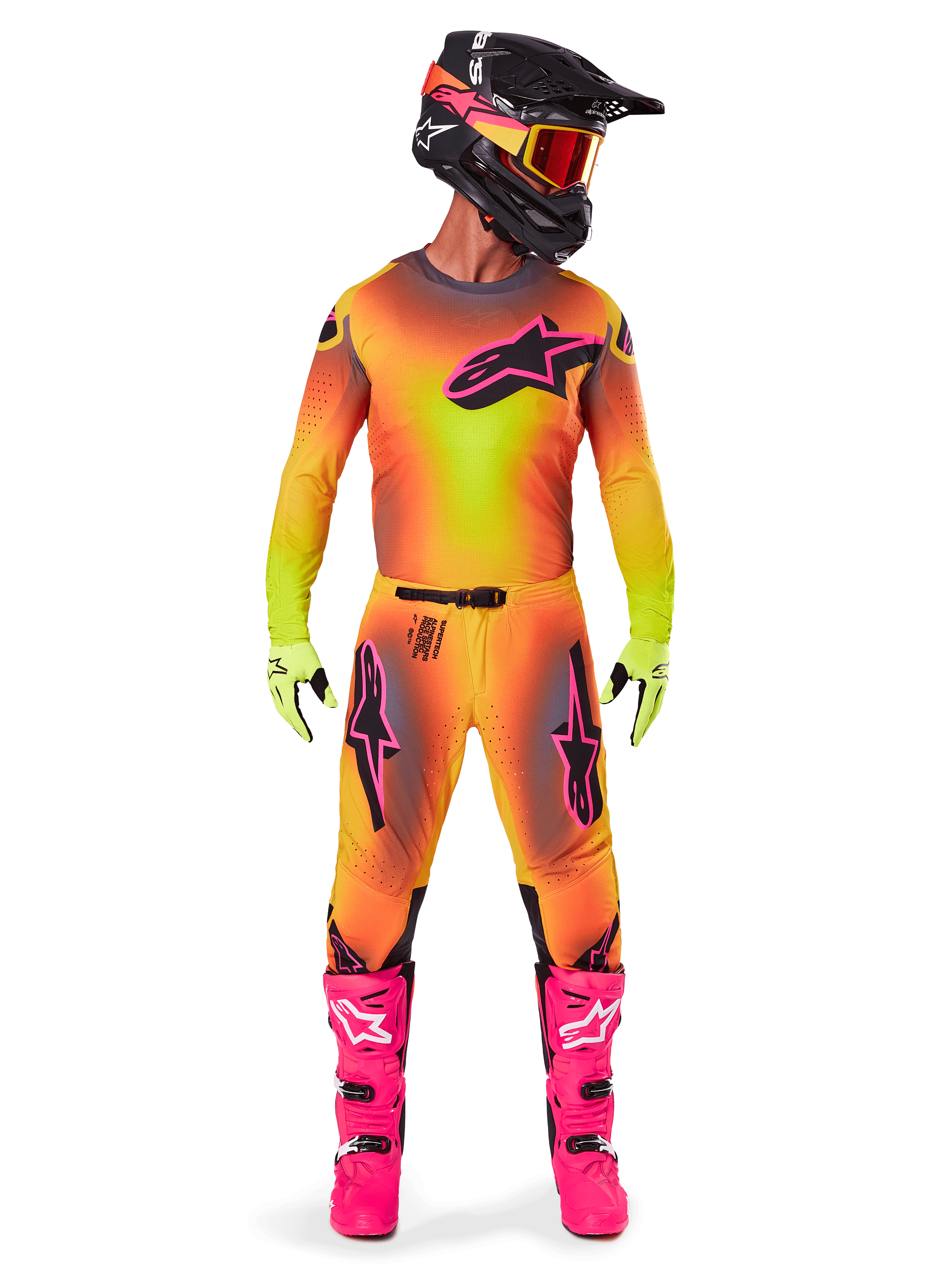 Motocross rider wearing complete racing gear, 2025 Supertech Lipan Jersey and Pants in a yellow and orange gradient with pink accents, black helmet with matching pink graphics, bright pink boots, and lime green gloves, coordinated Alpinestars off-road racing outfit.