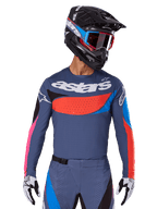 Alpinestars 2025 Techstar Dreem Jersey, Motocross Jersey, Gray with blue, red, and pink accents, featuring laser-cut perforations and large chest branding, worn with matching pants and black racing helmet