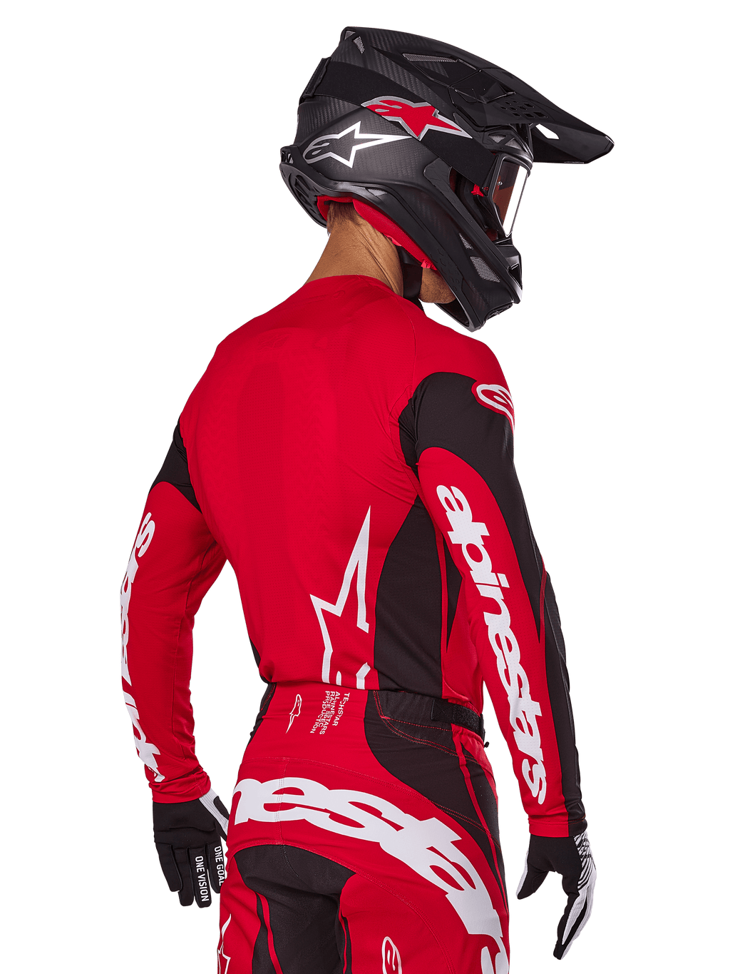 Motocross rider from back view wearing Alpinestars 2025 Techstar Dreem Gear Set, Red and black jersey with white sleeve branding, matching red and black pants with bold white logo on the seat, black carbon helmet with red accents, black and white gloves, professional off-road racing outfit.