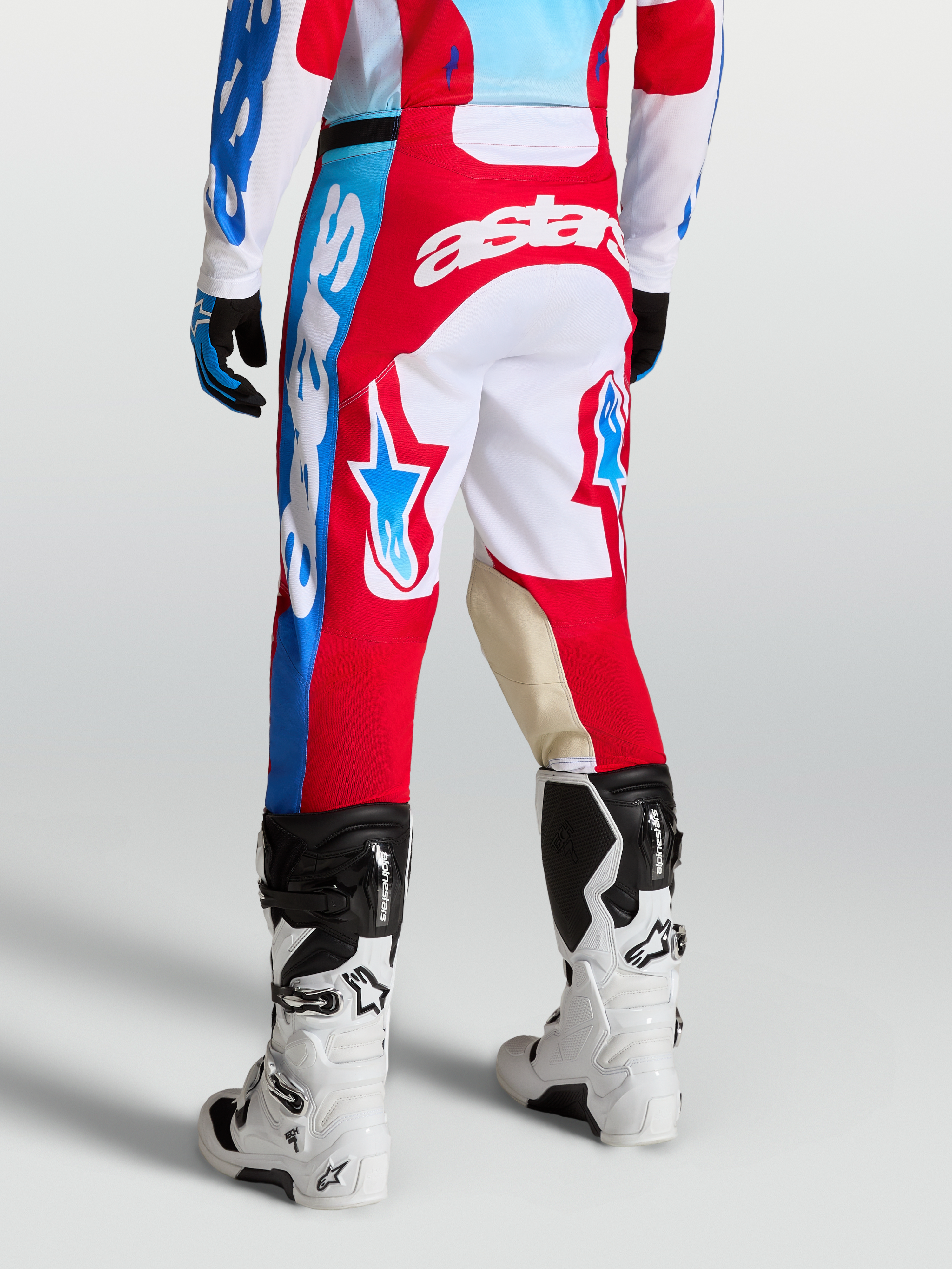 Racer Hunt Pants, Red and White motocross racing pants on-model with star graphics, goat leather knee panels, and ergonomic sport cut.