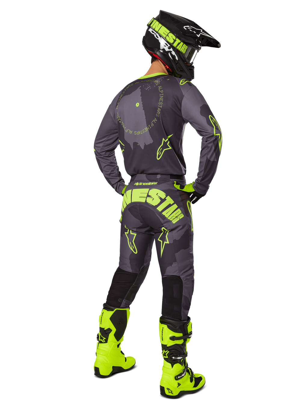 Rückansicht eines Motocross-Fahrers im 2025 Racer Hollow Gear Set in Dark Camo Yellow Fluo, bestehend aus einem grauen Camo-Trikot mit gelben Fluo-Akzenten, der passenden Motocross-Hose mit markantem Branding am Gesäß, leuchtend gelben Fluo-Stiefeln und einem schwarzen Helm mit gelber Brille.