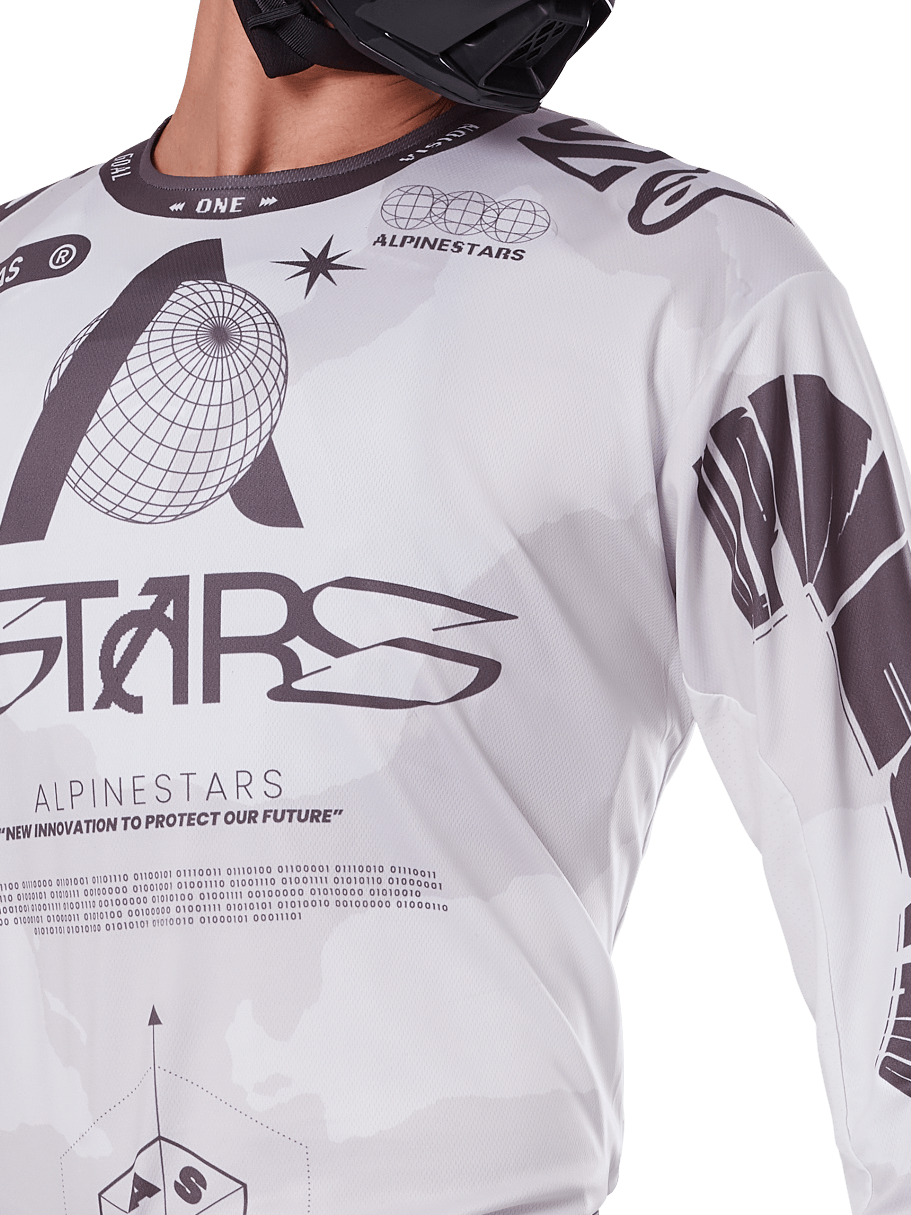 Nahaufnahme des Alpinestars 2025 Racer Hollow Jerseys, Weiß und Grau, mit schwarzen Grafikdrucken, Globus-Logo und Binärcode, technische Motocross-Bekleidung für das Gelände