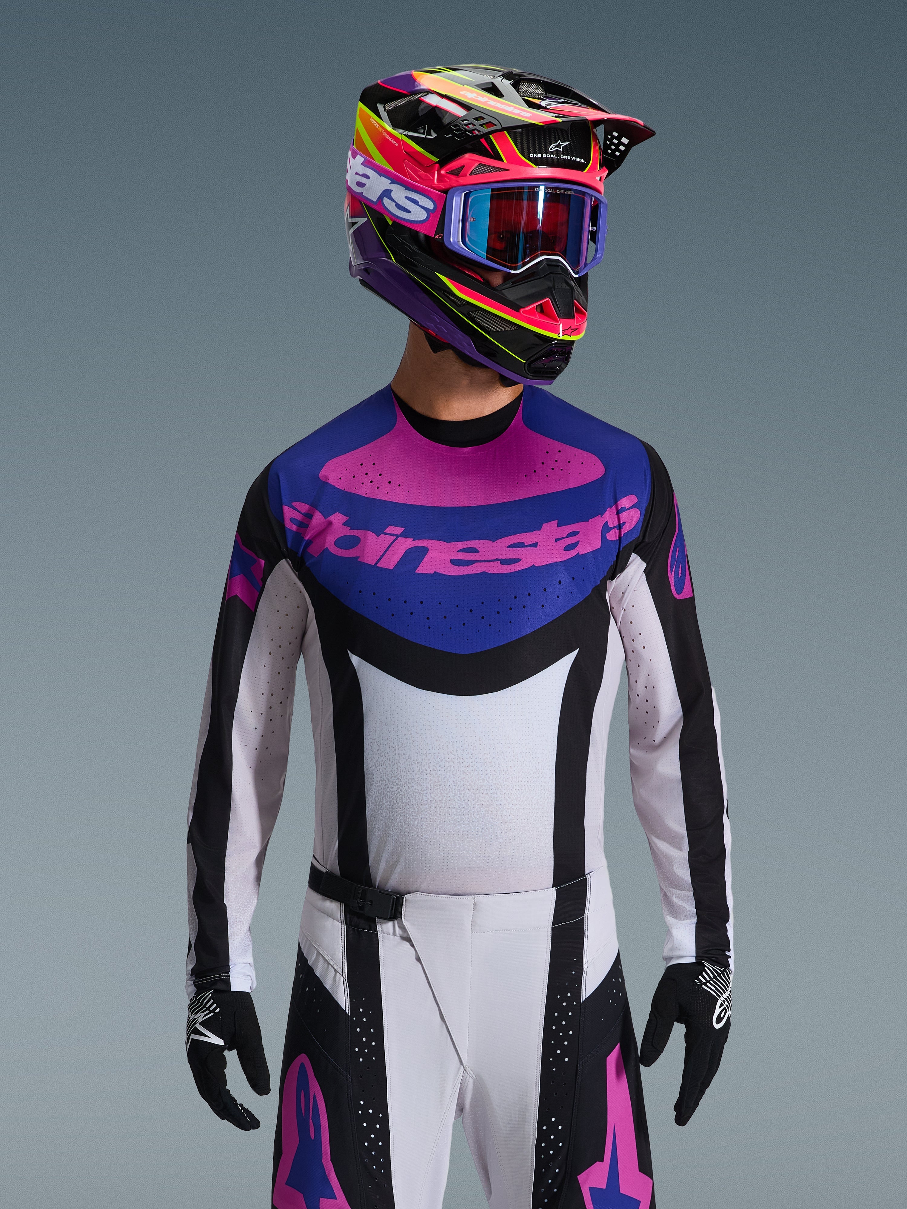 Alpinestars 2026 Techstar Knif Jersey, Motocross Jersey, Black Light Gray and Purple, pink Alpinestars logo on the chest, worn with matching colorful helmet and motocross pants, athletic race fit with laser-cut perforations for ventilation