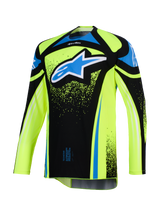 Alpinestars 2026 Techstar Nomur Trikot, Motocross-Trikot, Fluo-Gelb und Schwarz mit blauen Akzenten, großes blau-weißes Astar-Logo auf der Brust, Splatter-Grafikdetails, langärmlig, sportliche Offroad-Rennausrüstung