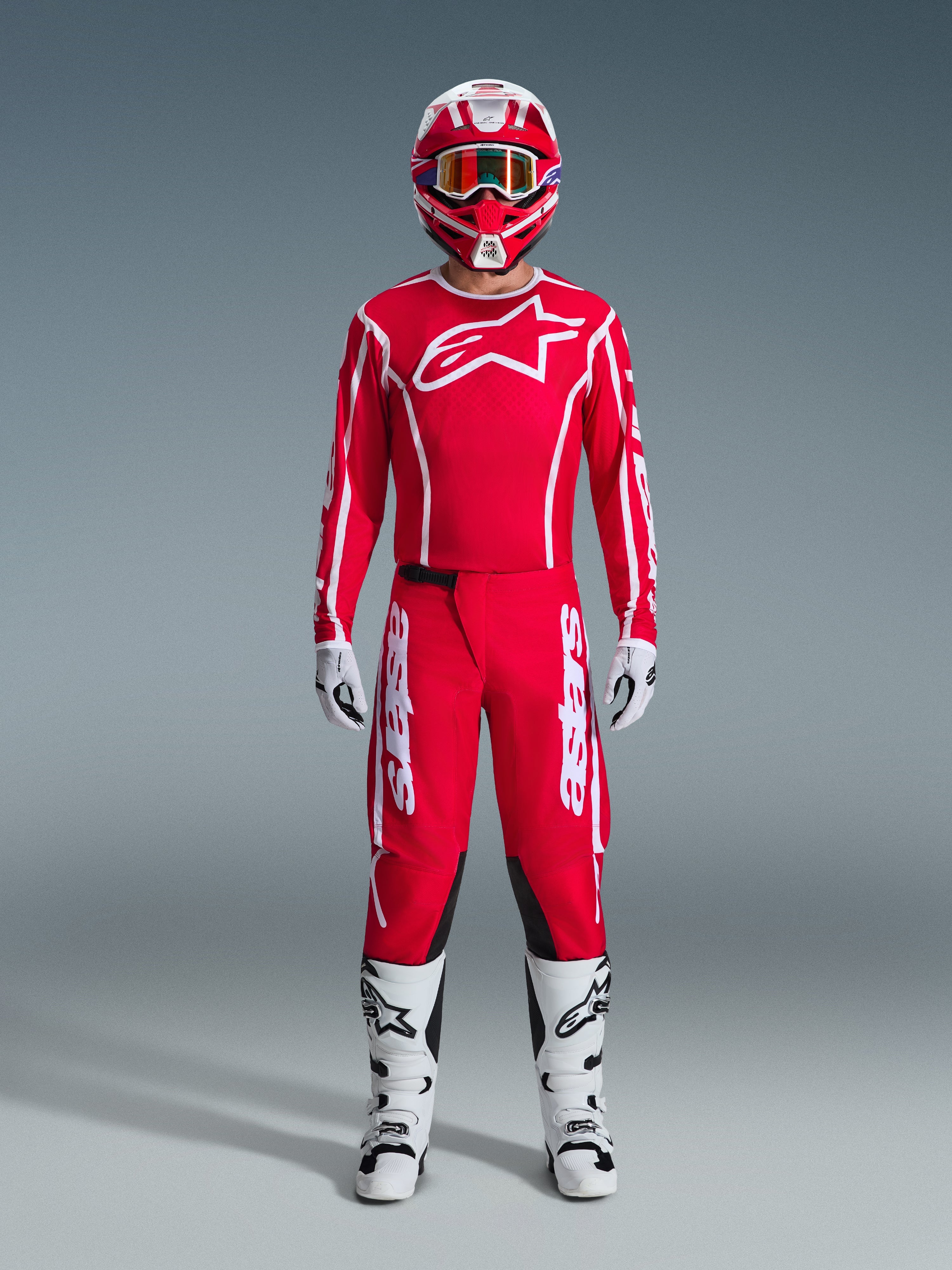 2026 Fluid Apex Gear Set, Motocross Outfit, Red and White, full racing kit including a red long-sleeve jersey with a white star logo, red pants with white branding and black inner knee panels, white boots with black accents, white gloves, and a matching red and white helmet with goggles, complete off-road racing ensemble