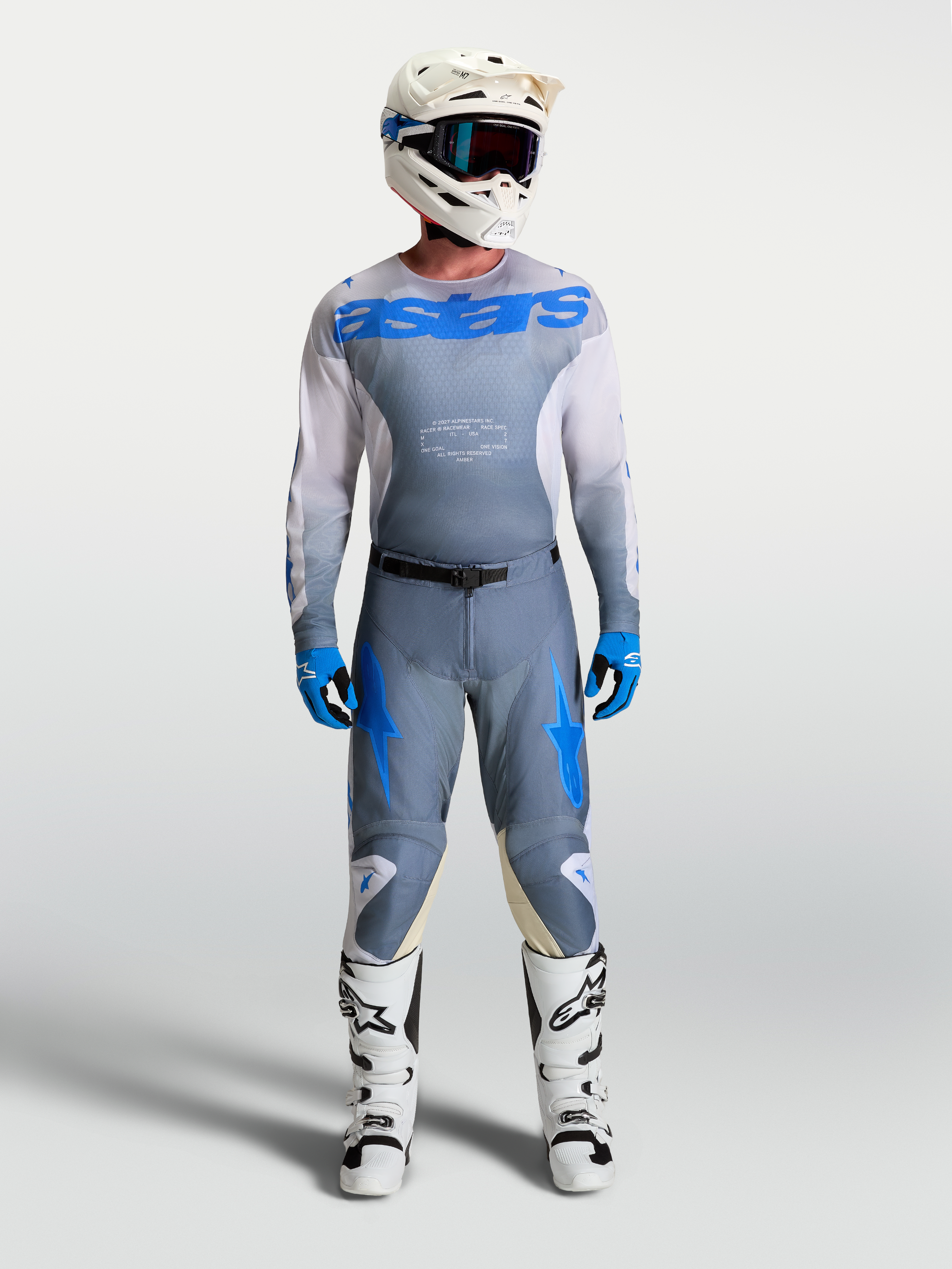 Alpinestars 2027 Racer Amber Jersey and Gear Set, motocross outfit in Ash Gray and Blue, on-model with white helmet and boots.