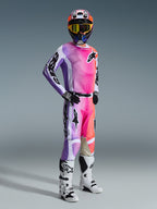 Alpinestars 2026 Racer Air Portl Gear Set, Motocross rider in full racing gear, jersey and pants featuring a vibrant purple, pink, and orange gradient with black Alpinestars logos, white and black accents, coordinated multi-colored helmet with yellow-tinted goggles, white and black motocross boots, black and white gloves.