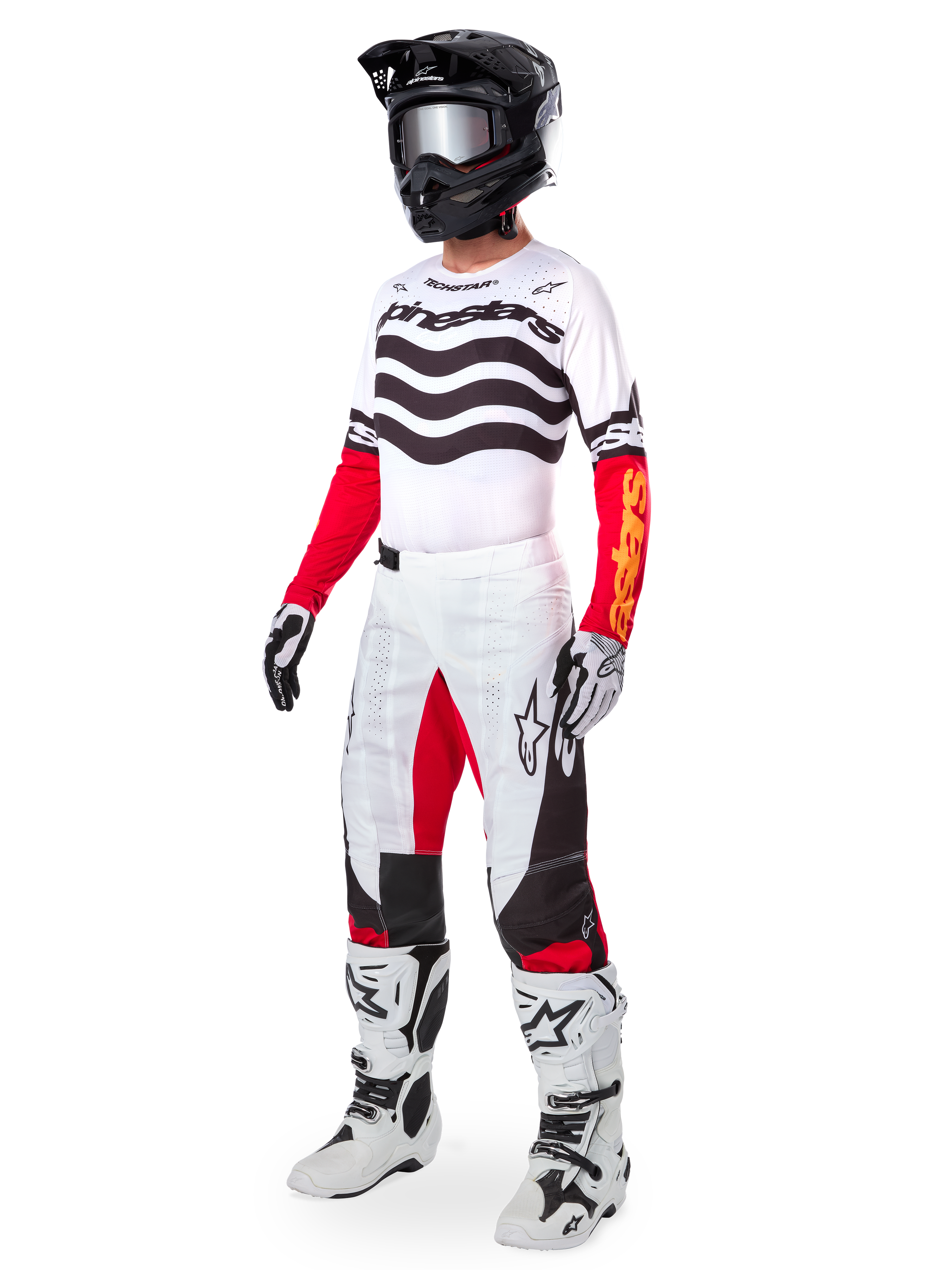 Alpinestars Limited Edition Techstar Deep Gear Set, vollständige Motocross-Rennausrüstung, weißes Trikot mit schwarzen Wellenmustern und roten Ärmeln, weiße Hose mit roten und schwarzen Akzenten, schwarzer Helm mit silberner Brille, weiß-schwarze Handschuhe, weiße Stiefel, abgestimmtes MX-Rennoutfit