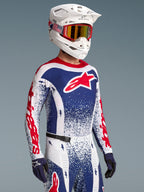 Alpinestars Techstar Unity Bekleidungsset Limited Edition, Motocross-Rennausrüstung, Weiß, Blau und Rot, Stern-Grafiken.