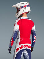 Alpinestars Techstar Unity Bekleidungsset Limited Edition, Motocross-Outfit in Rot, Weiß und Blau mit Sternengrafiken.