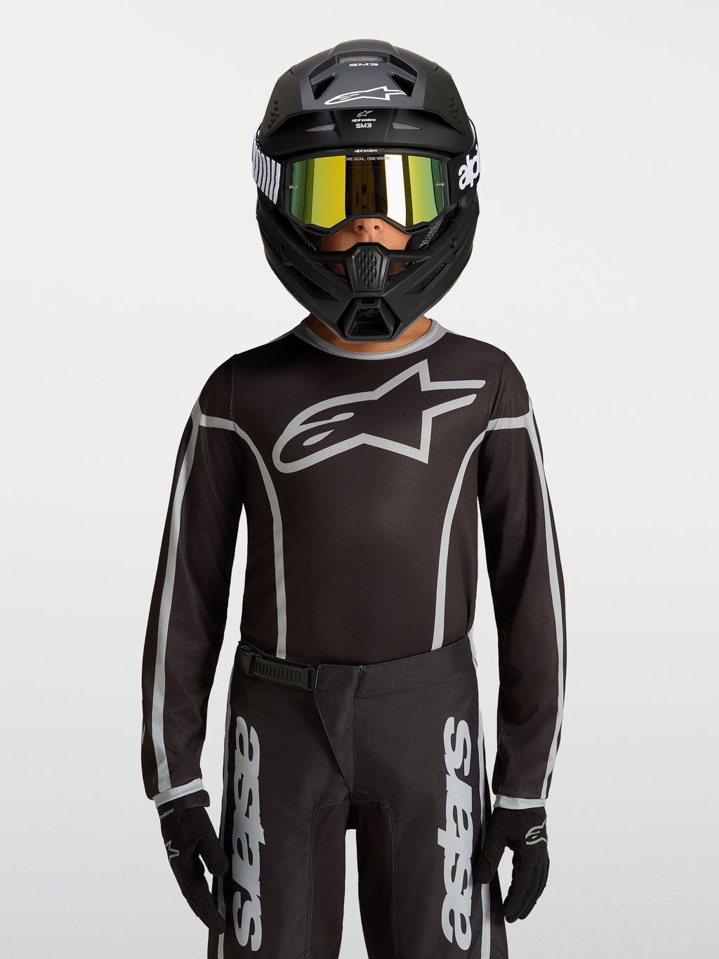 Alpinestars Fluid Apex V2 Jugend-Trikot, Motocross-Ausrüstung in Schwarz und Silber, ergonomische Passform aus Polygewebe.