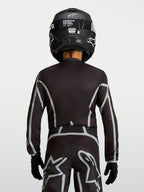 Alpinestars Fluid Apex V2 Jugend-Trikot, Motocross-Oberteil in Schwarz und Silber, ergonomische Passform mit verlängerter Rückenpartie, Rückansicht.