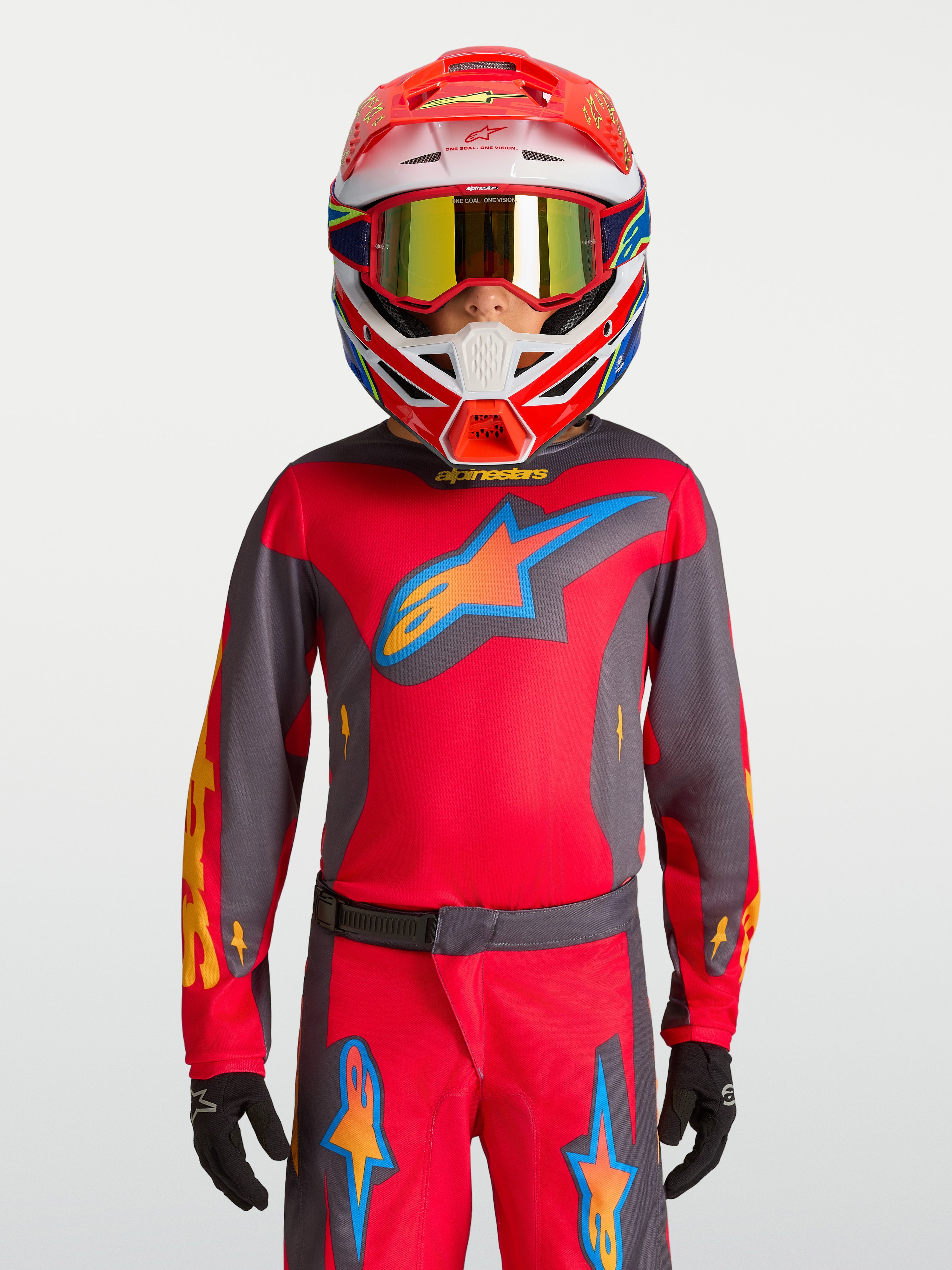 Alpinestars 2027 Youth Fluid Hunt Jersey, youth motocross gear, Fire Red and Graystone, on-model with racing helmet.