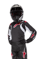 Youth 2024 Racer Lucent Jersey, Motocross Jersey, Black White and Red, worn by a youth rider with a black helmet and matching pants, featuring red star logos and white graphic accents, performance off-road apparel for dirt bike racing