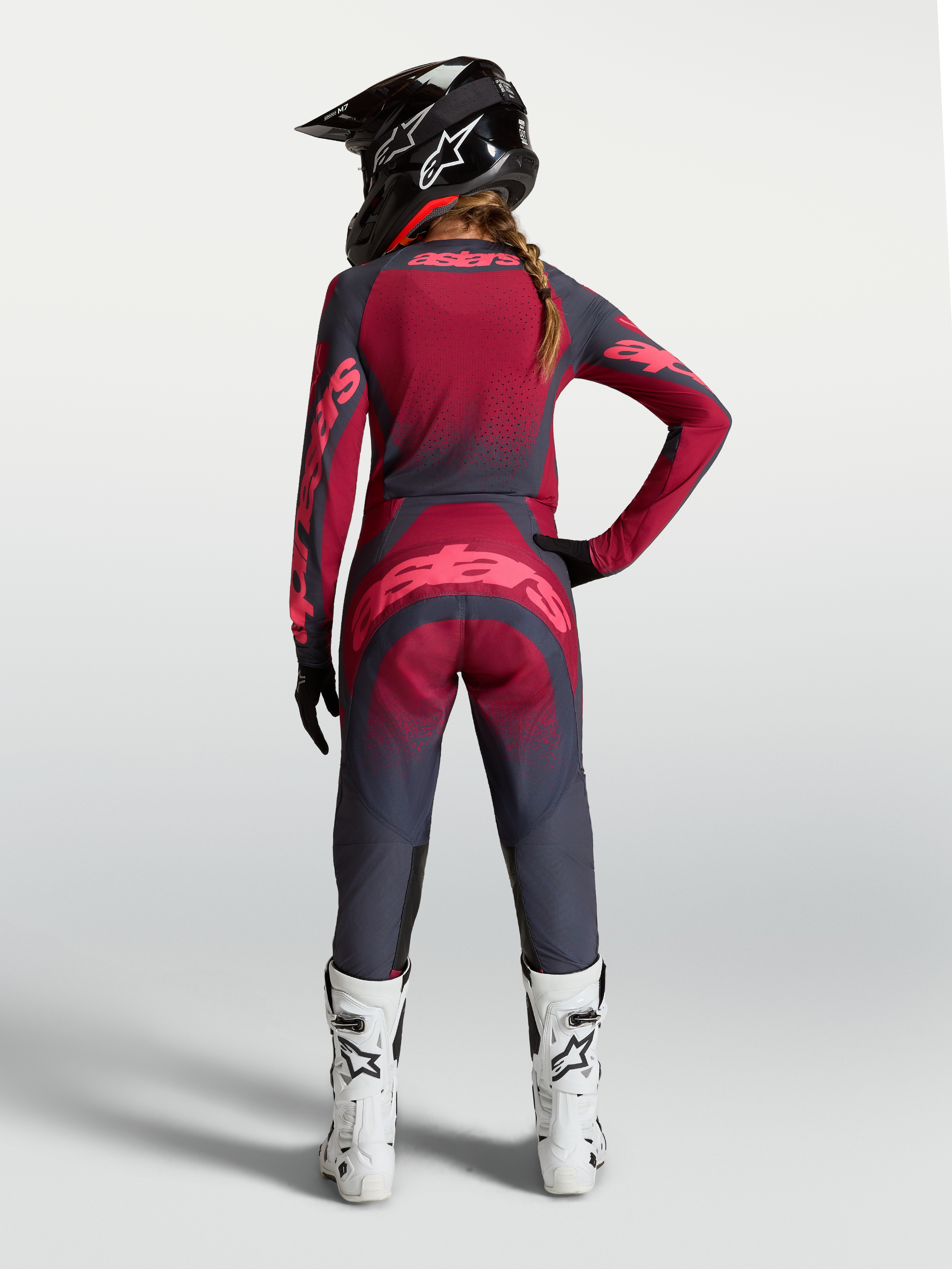 Alpinestars Stella Techstar Swan Jersey, women's crimson and dark gray motocross gear with ventilation, rear on-model view.