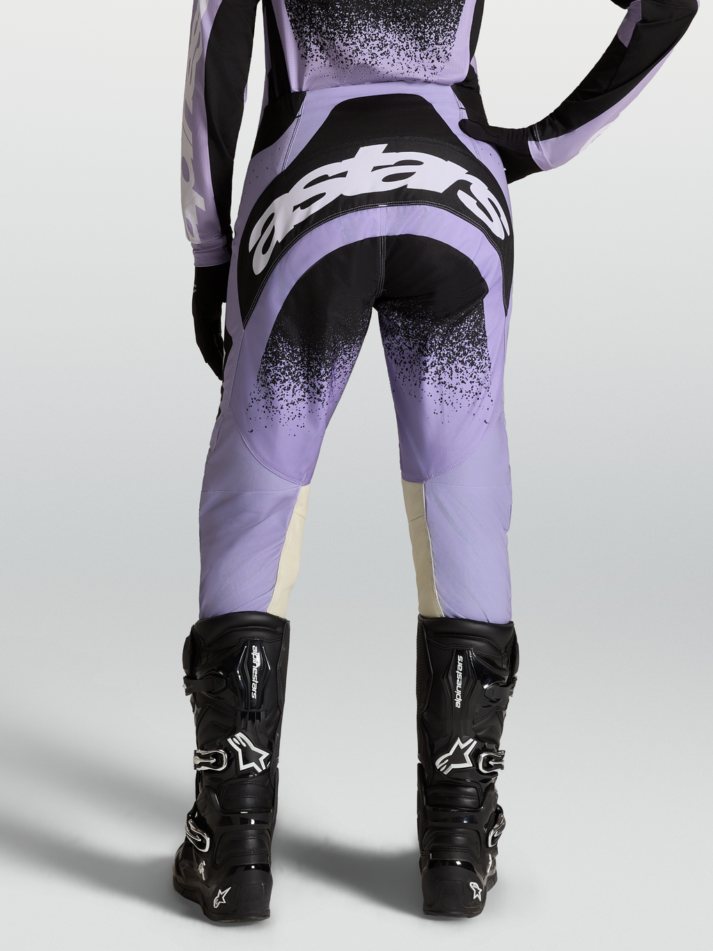 Alpinestars Stella Techstar Swan Pants, women's motocross gear in purple and black with white logos, worn on-model with black boots.