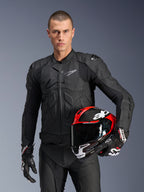 Alpinestars Dusk Leather Jacket, Black Motorcycle Jacket, premium leather construction with padded armor details, male model holding red and black racing helmet, wearing matching leather pants and gloves, professional motorsport road gear