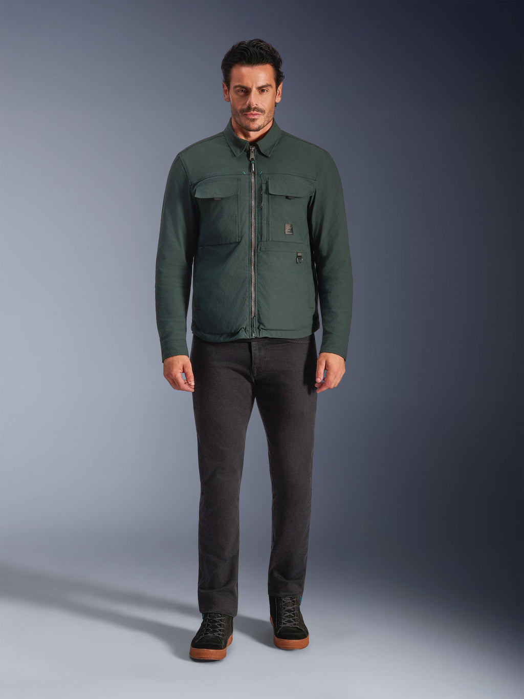 Alpinestars Bryon WR Overshirt, Water-Resistant Motorcycle Jacket, Dark Emerald, worn with black pants and black boots, featuring waxed canvas construction, chest cargo pockets, and a modern urban design.